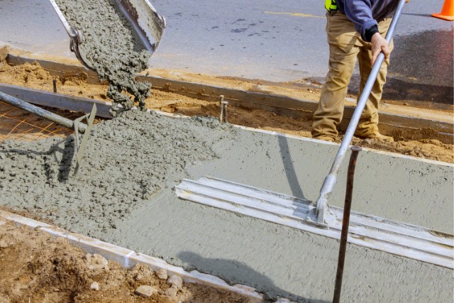 Concrete being poured into sidewalk forms in Joliet project