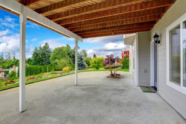 Large covered concrete patio off the back of a Joliet home