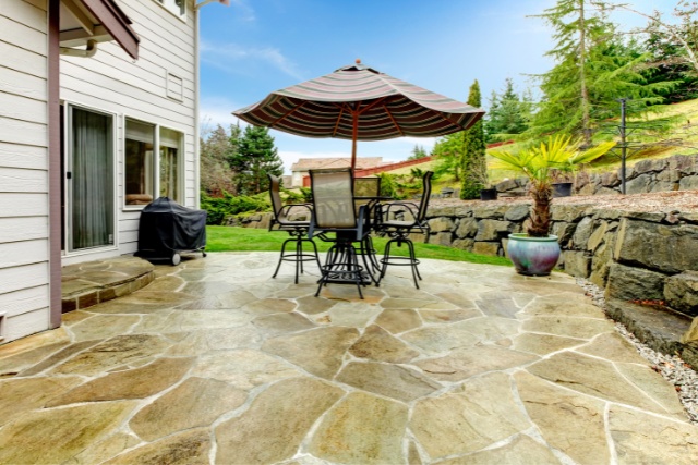 A flagstone stamped concrete patio with freshly applied concrete sealer in Joliet, IL.