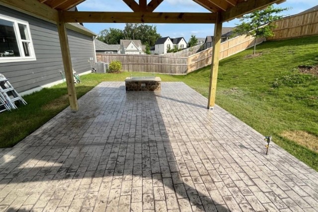 Covered back patio with a earthy colored stamped concrete brick pattern.