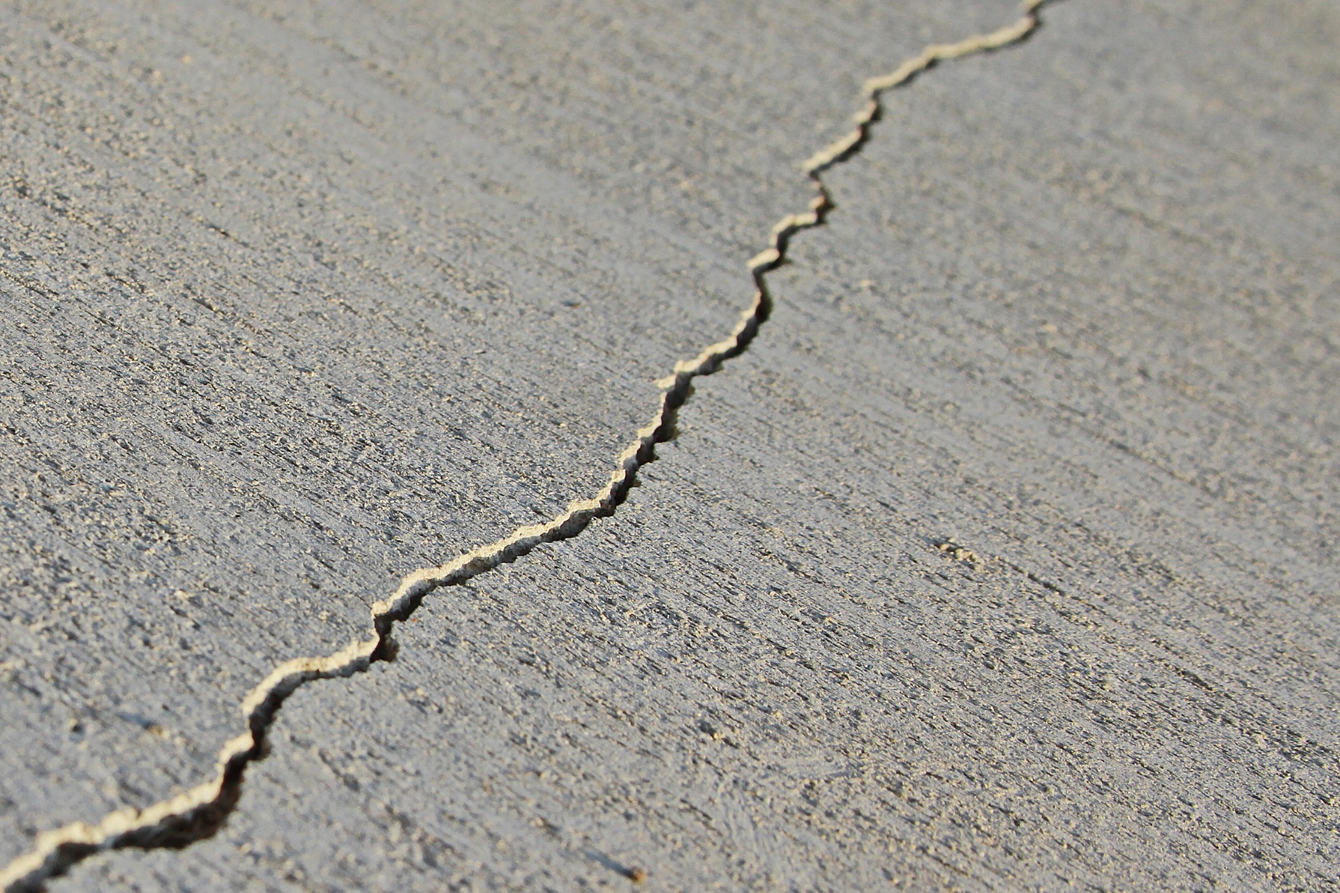 A single crack running across a concrete slab.