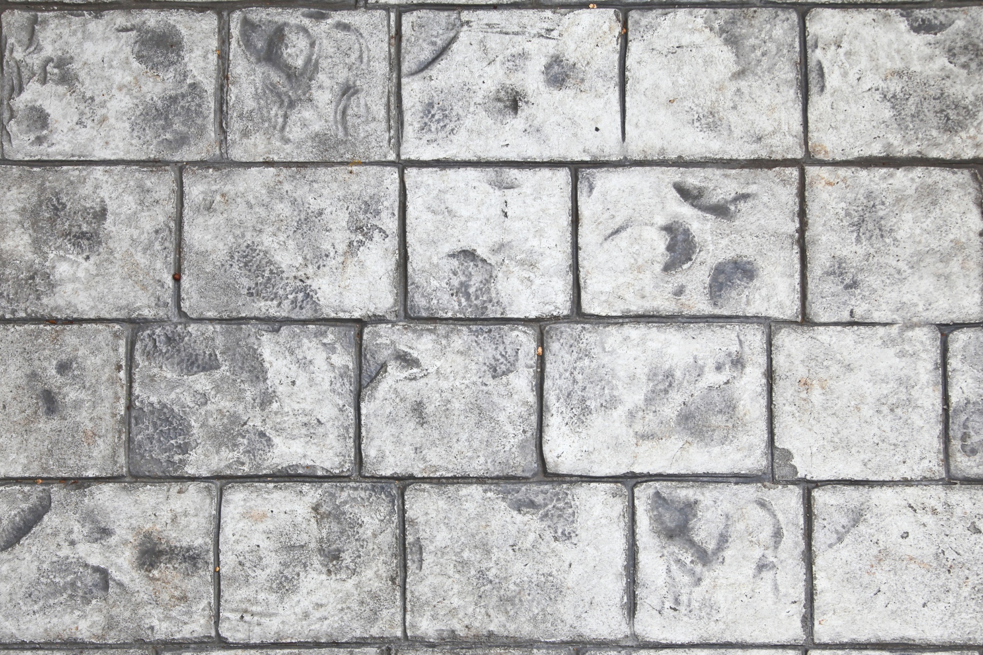 Stamped concrete blocks in gray with darker gray indentations.